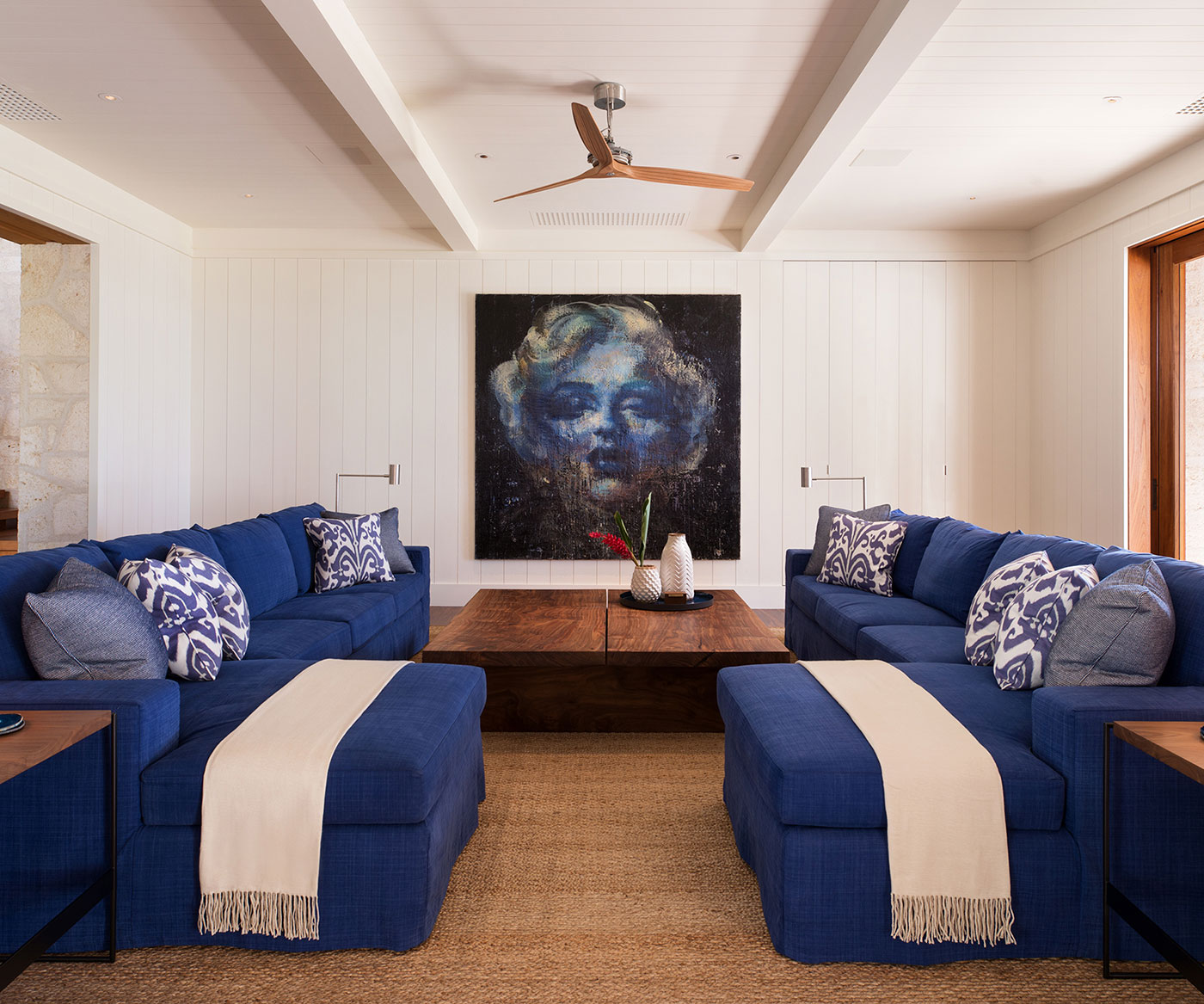 Facing blue upholstered sofas and chaises in a Maui living room